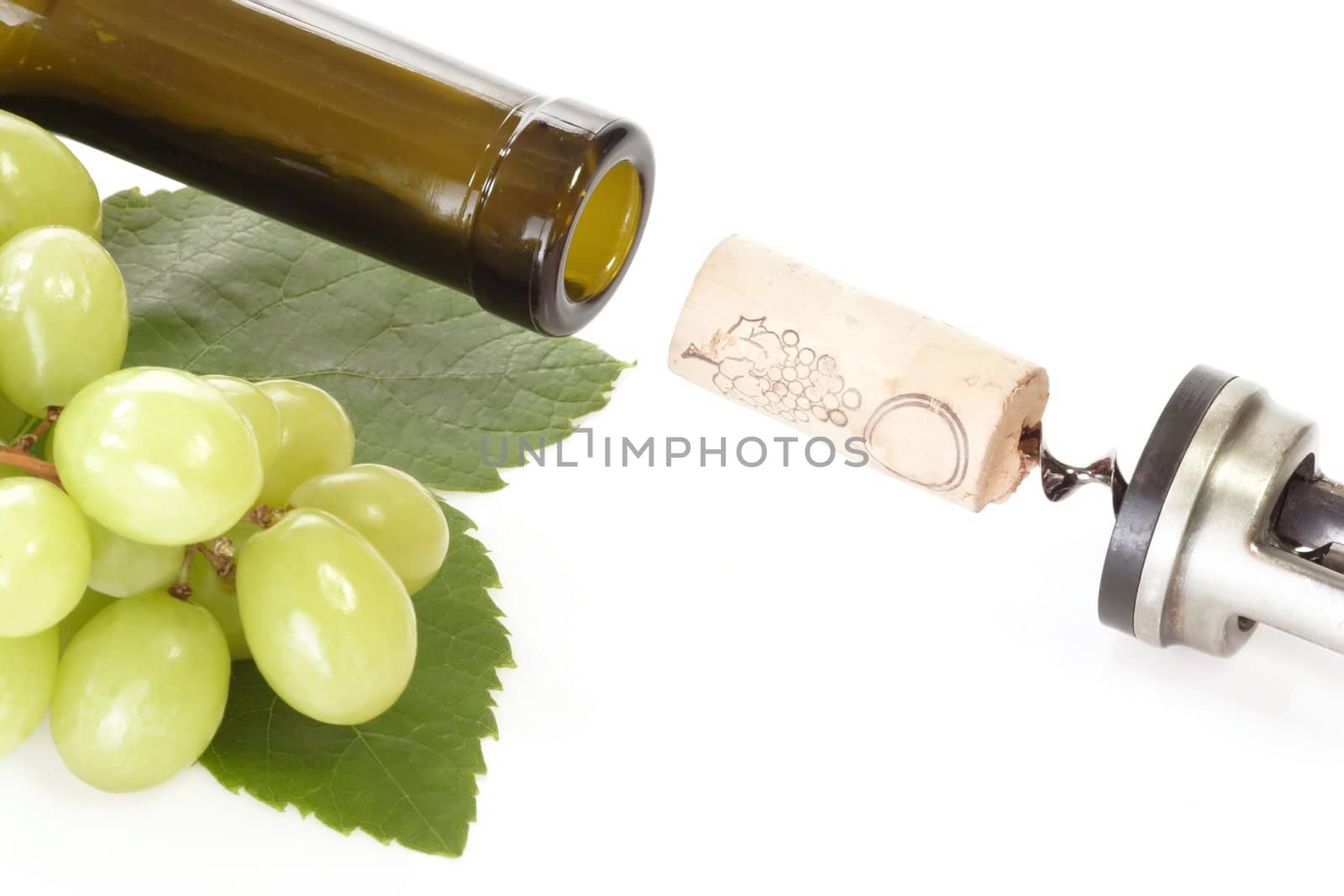 Corkscrew with wine cork, bottle and grapes on white background