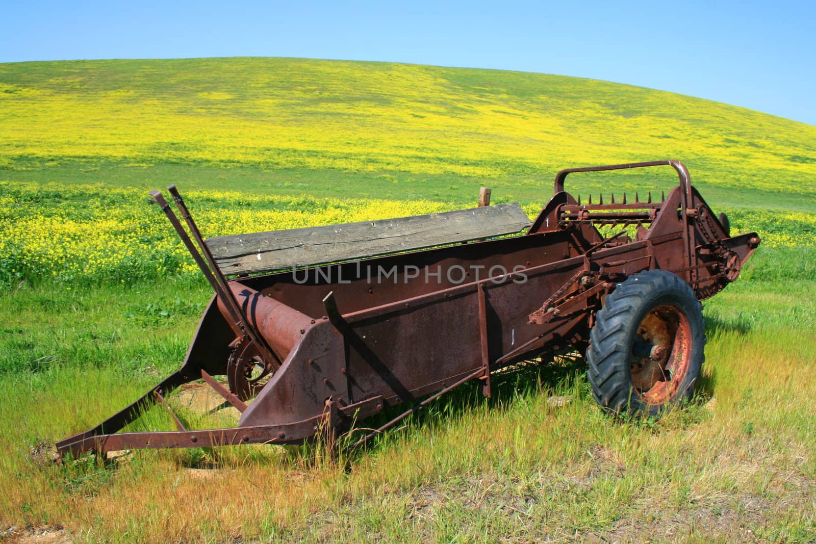 Close up of an old farm harvester.
