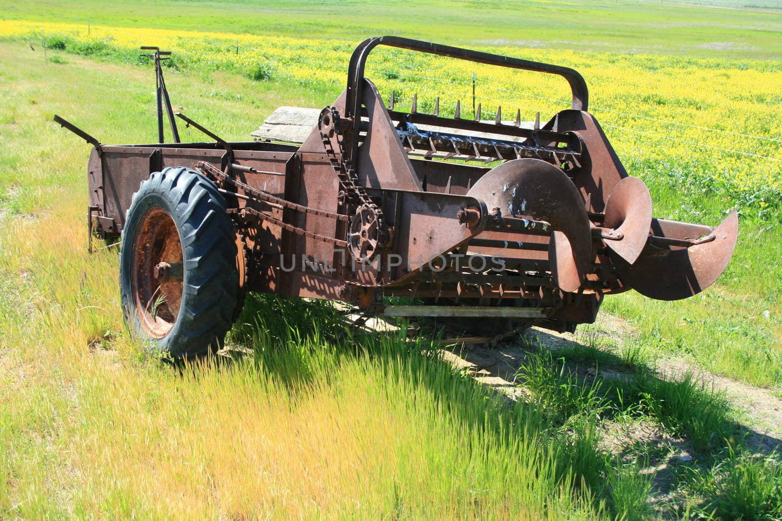 Close up of an old farm harvester.
