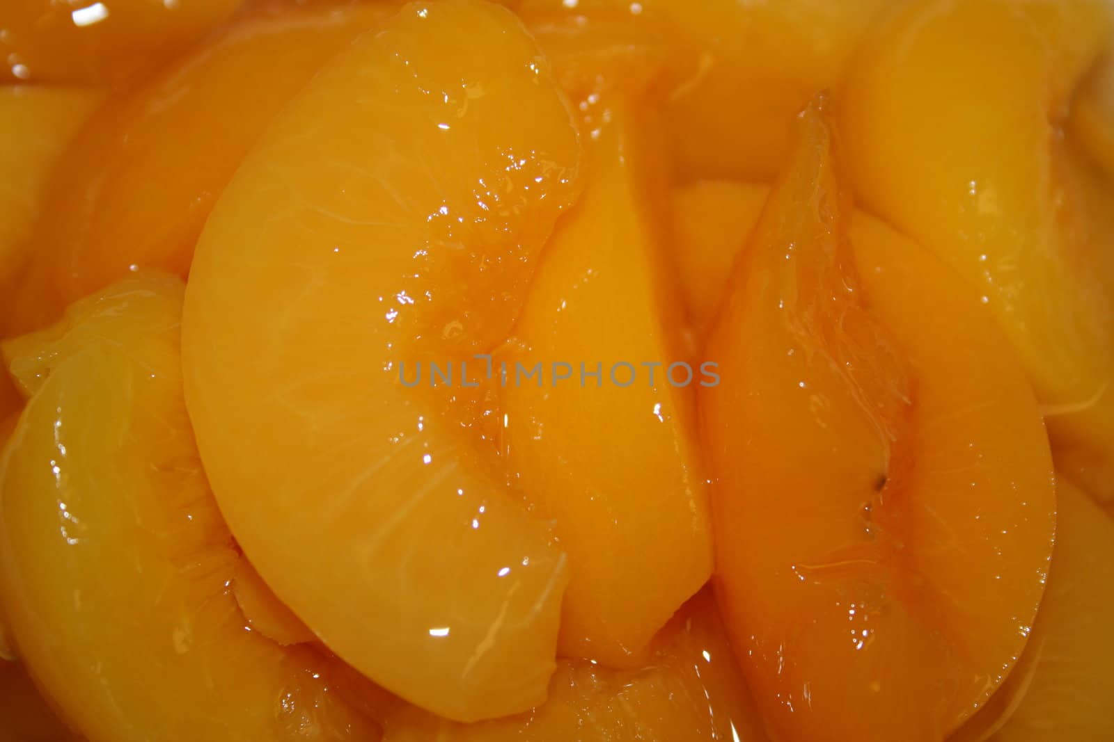 Close up of peaches in a sweet peach juice.
