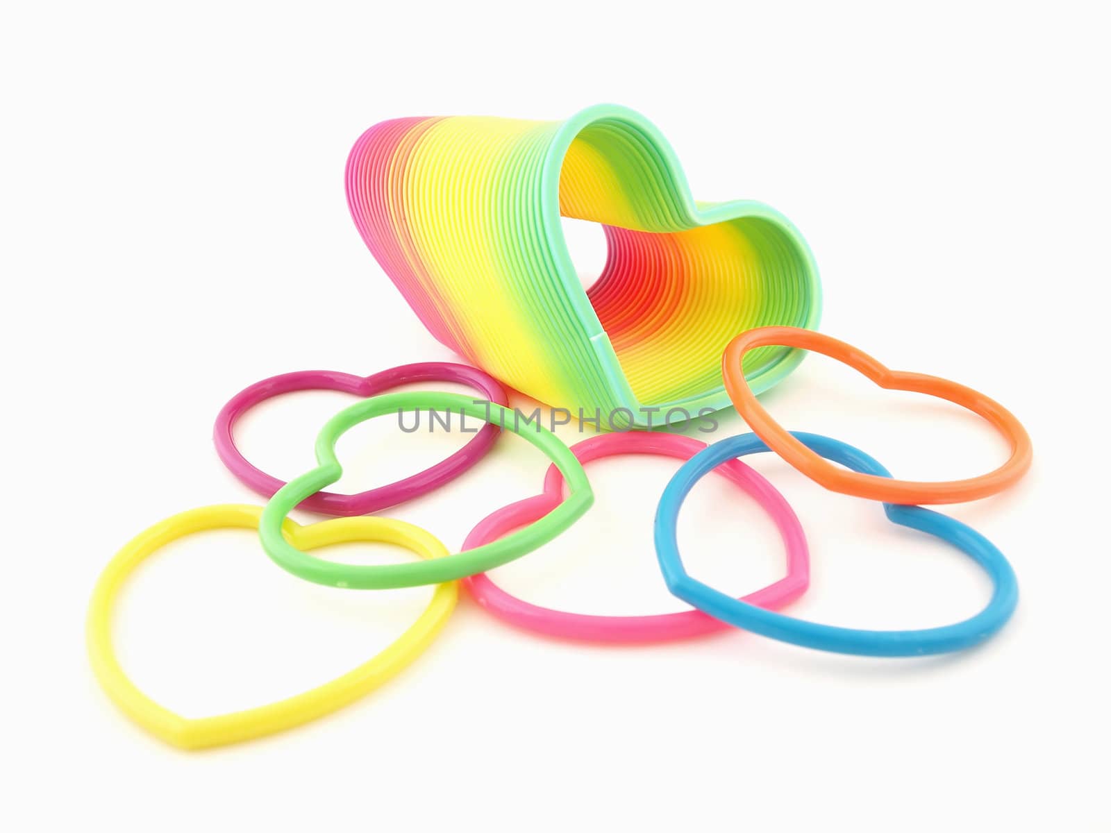 A group of colorful hearts and a heart shaped slinky isolated on a white background