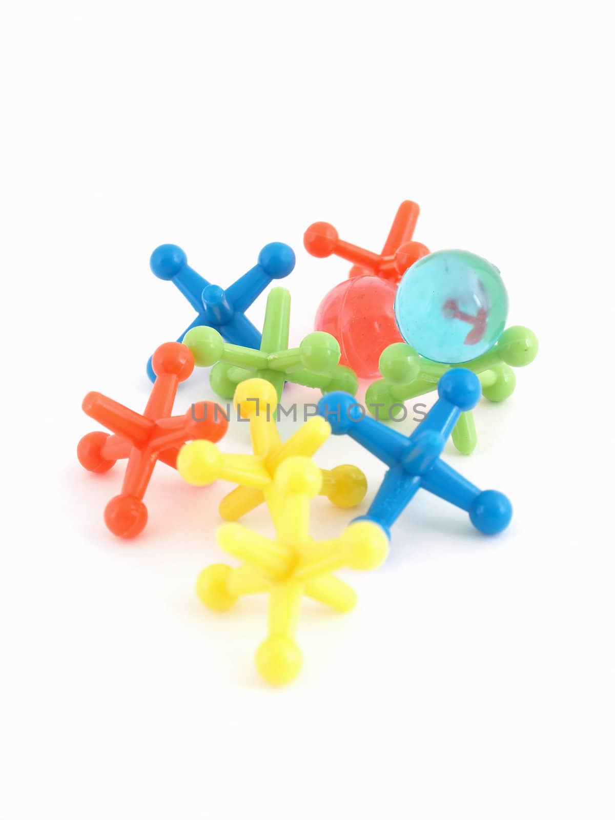 Colorful plastic toy jacks and balls isolated on a white background