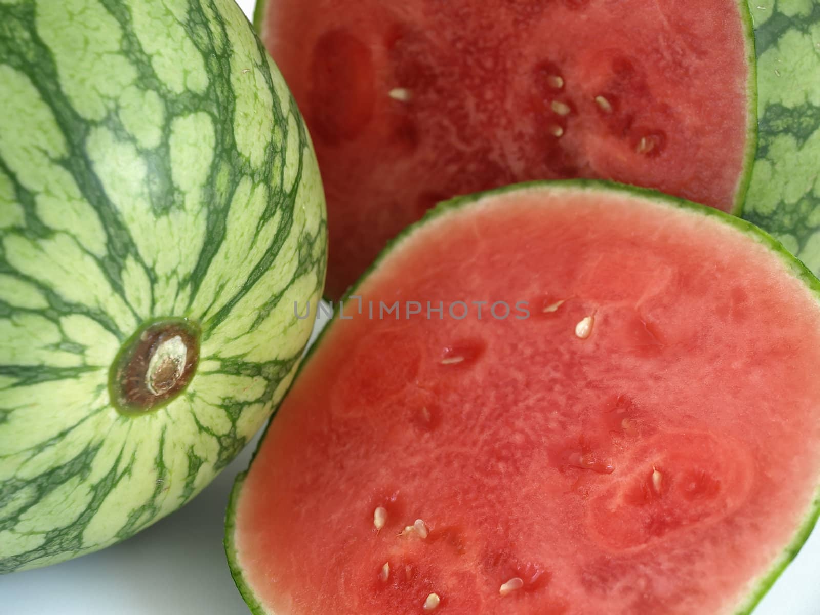 Close up shot of two juicy ripe watermelon studio isolated over a white background.
