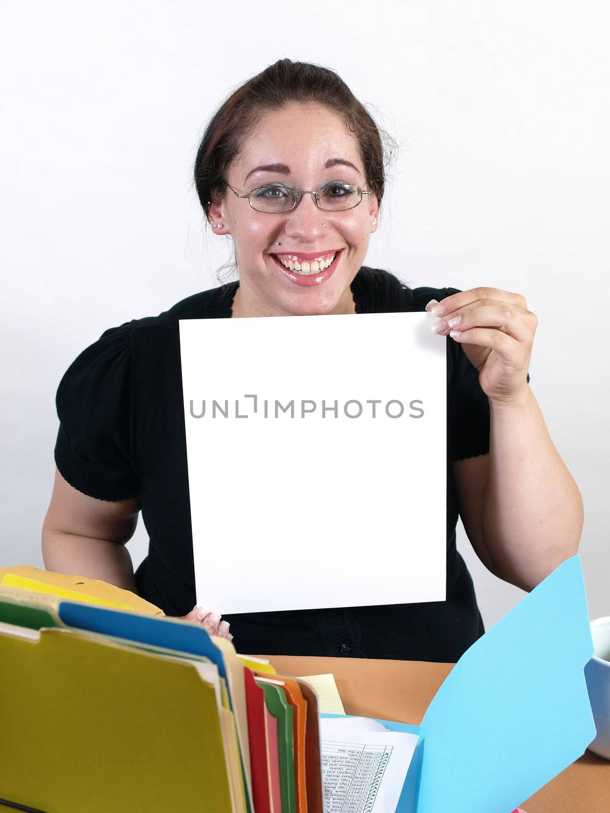A female office worker holds up a blank white sign.