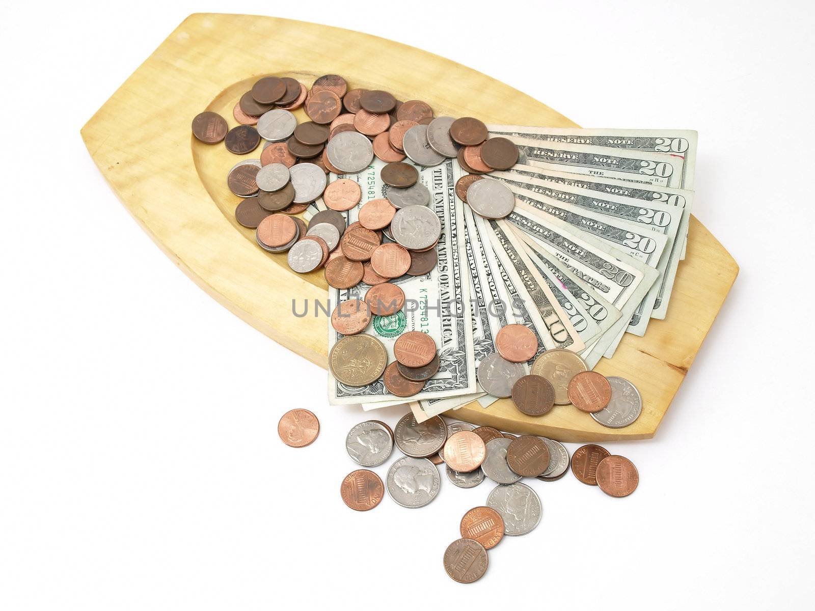 A wooden tray with US currency and coins. Studio isolated over a white background.