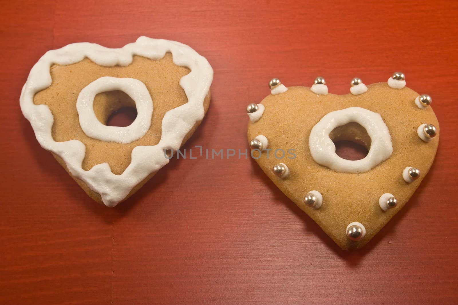 Decorated heart shaped cookies on red background