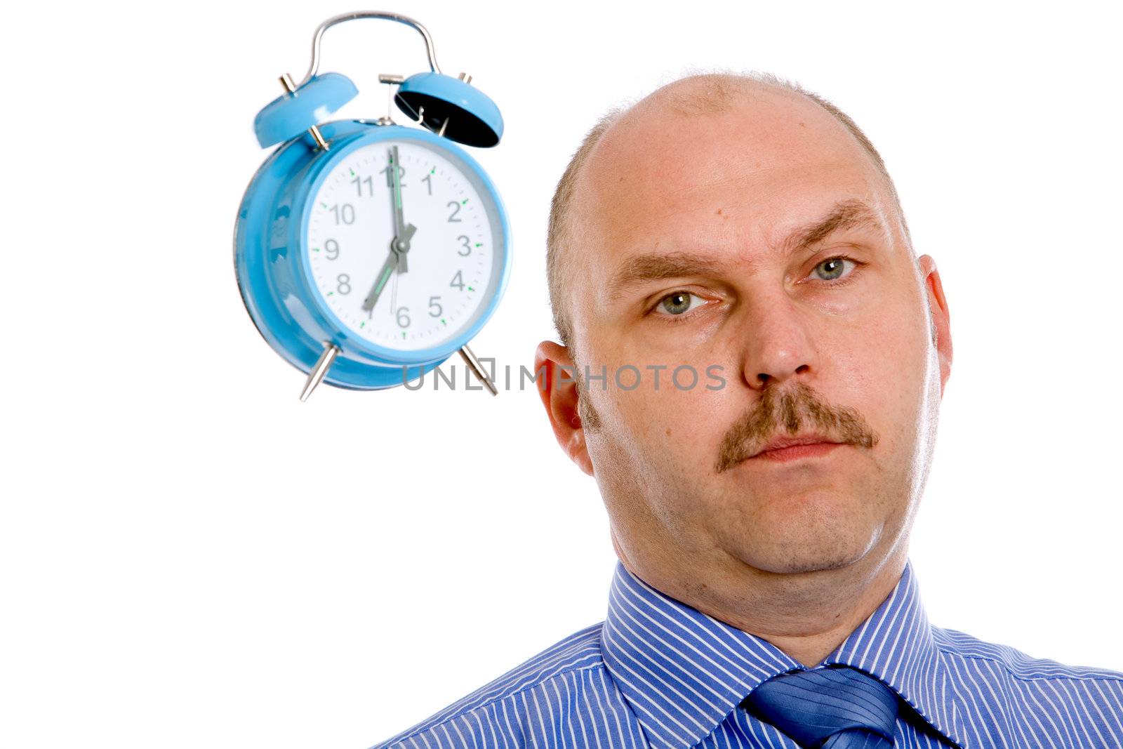 Businessman looking slightly annoyed with a clock next to his head