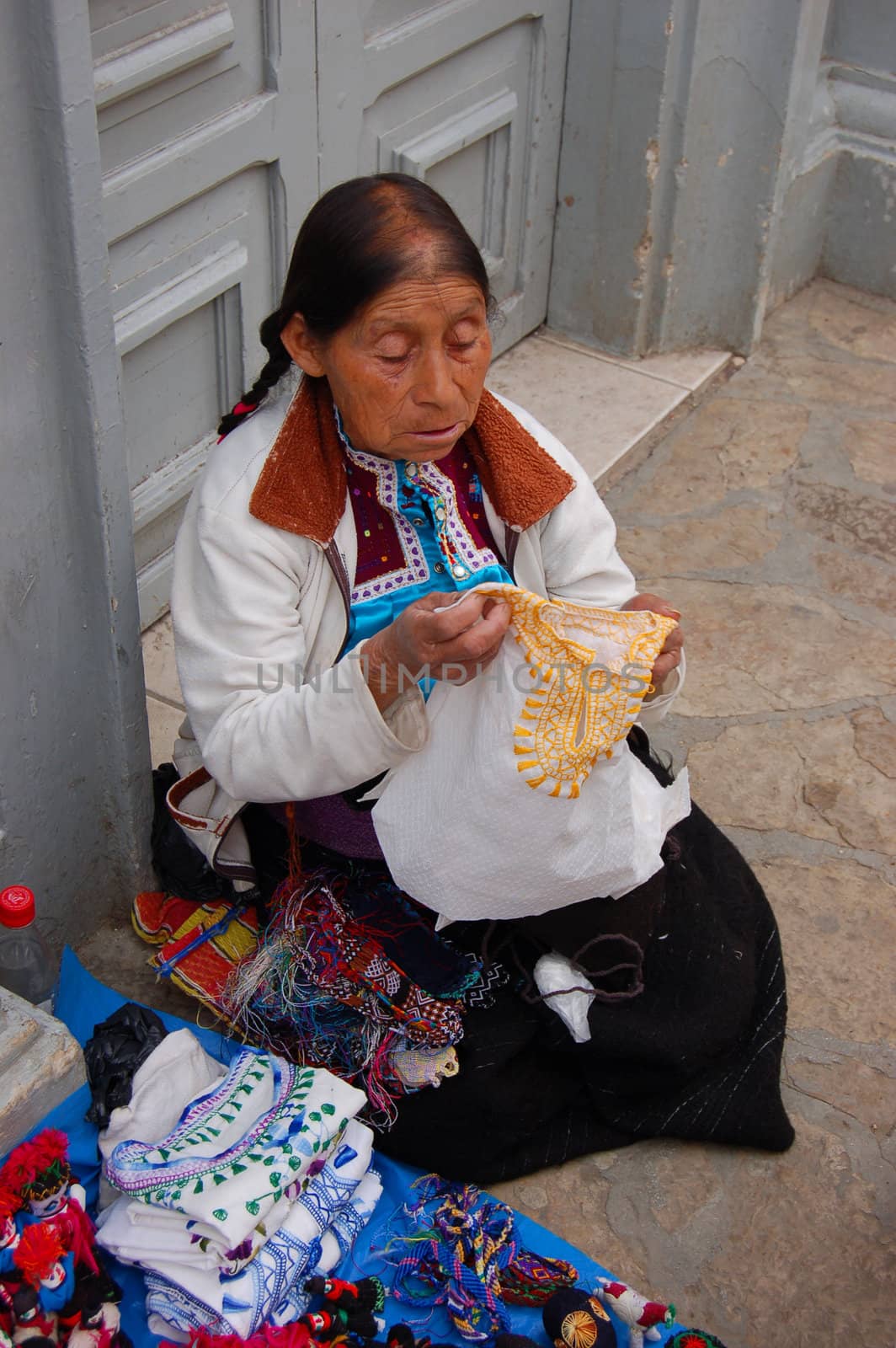 Old Mayan Woman selling shirts on the street