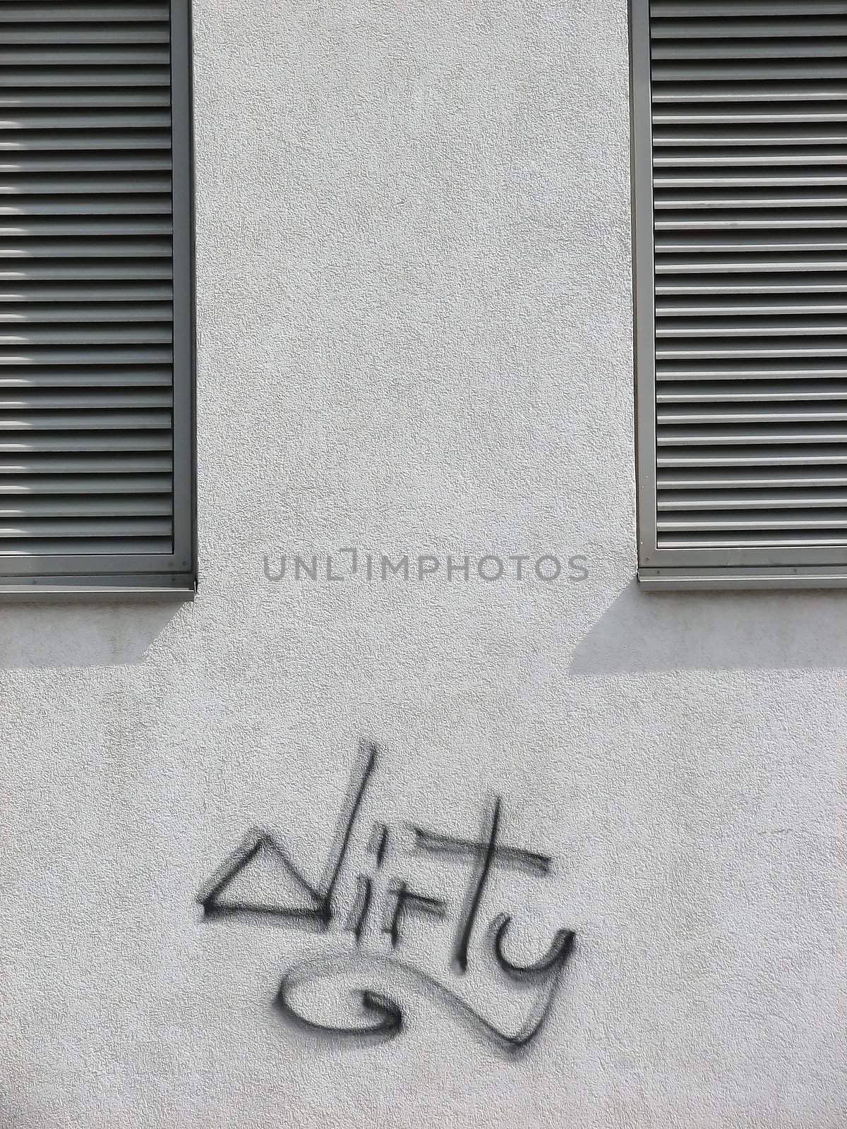 Graffiti 'dirty' written on a clean wall