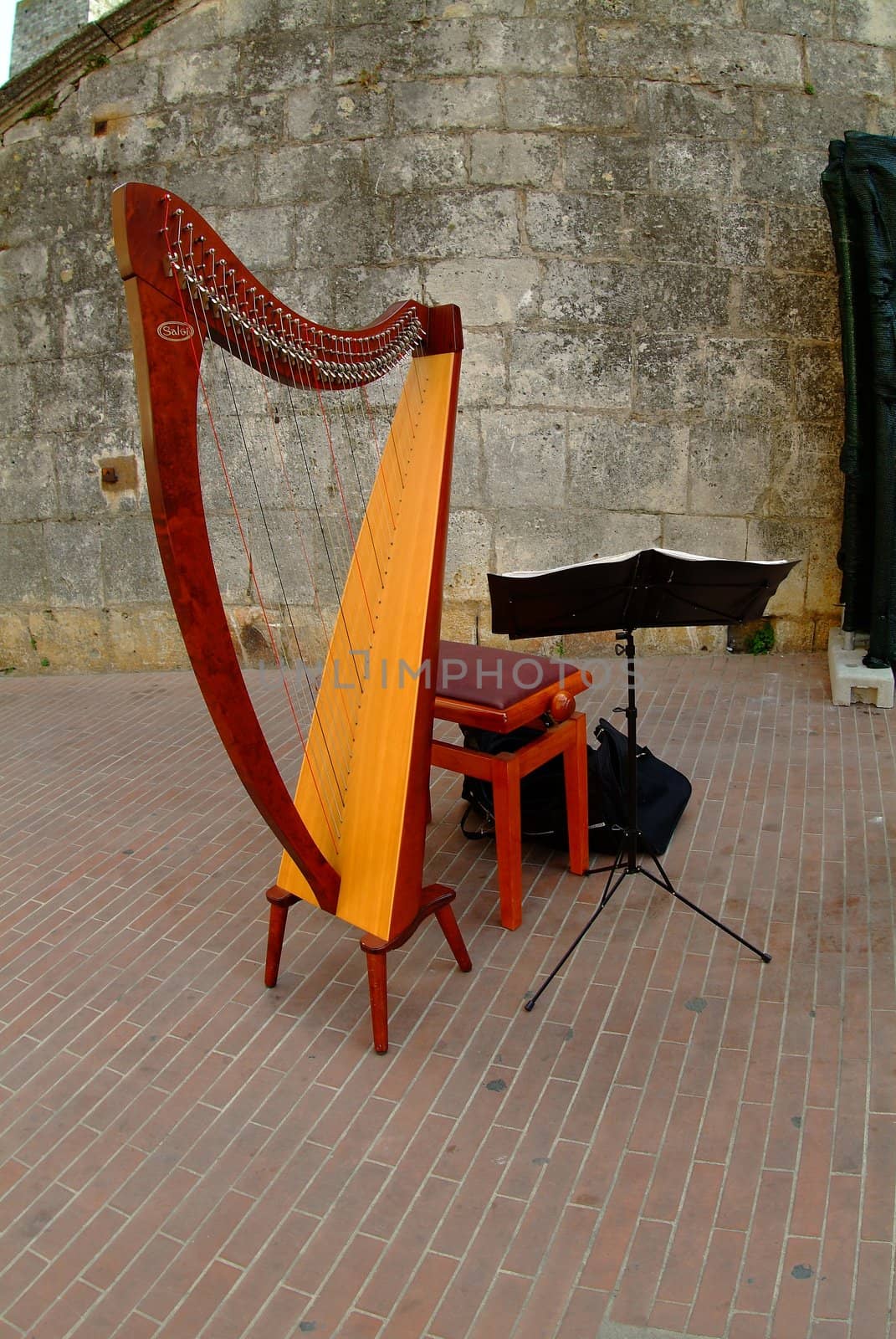 red harp with seat and music stand