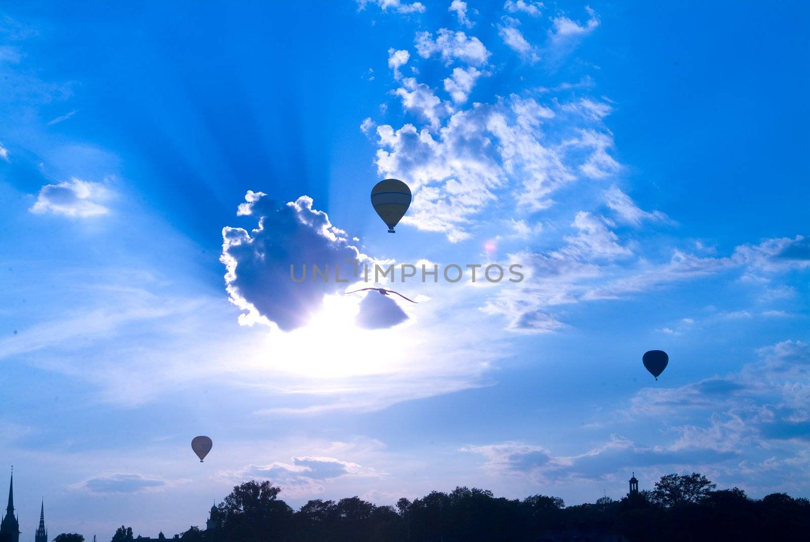 three ballon on cloudy sky