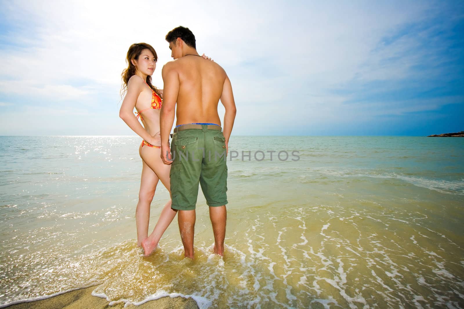 asian couple dating on the romantic beach