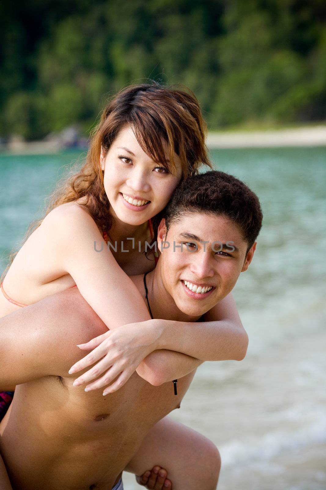 happy young couple by the beach having romantic time