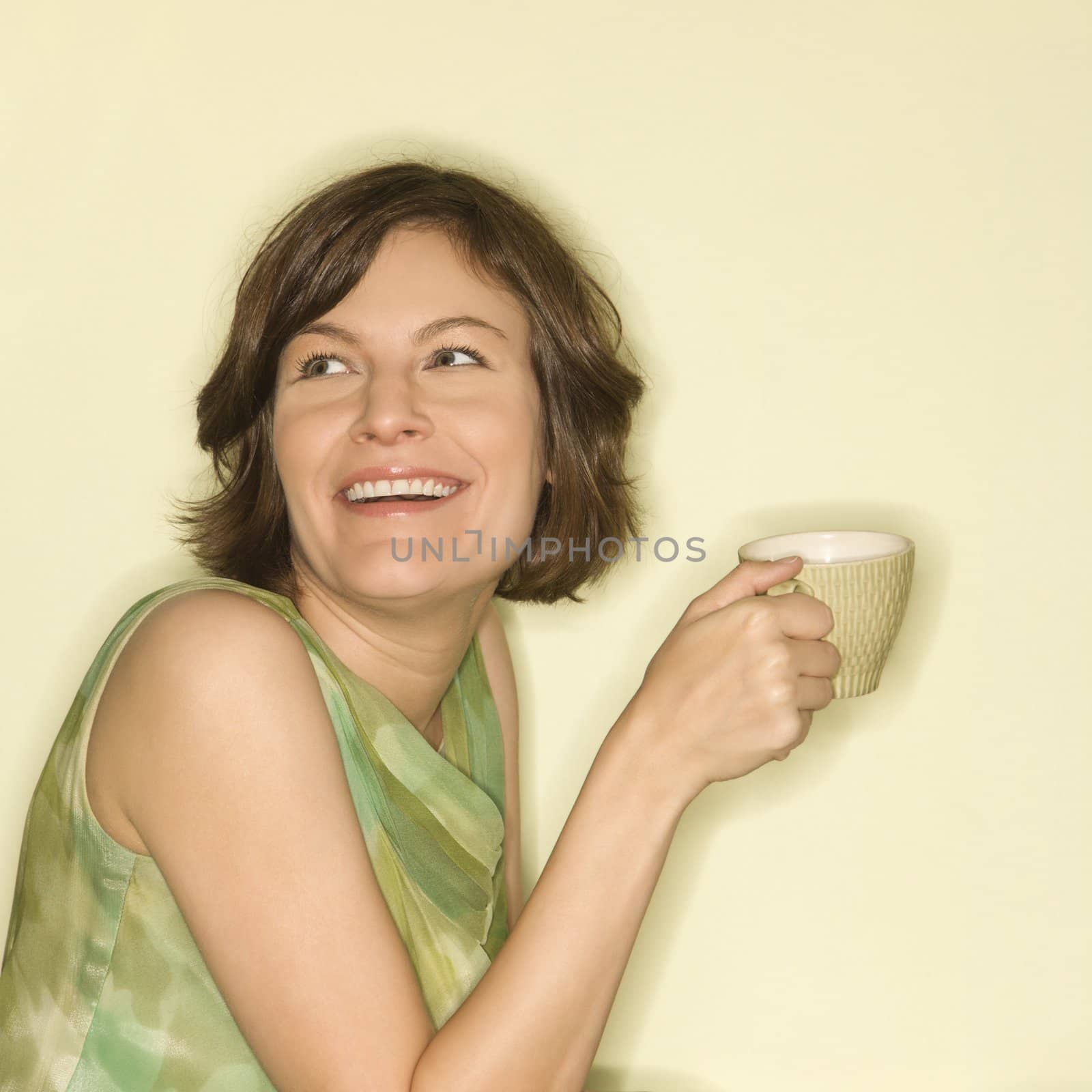 Woman smiling with cup. by iofoto