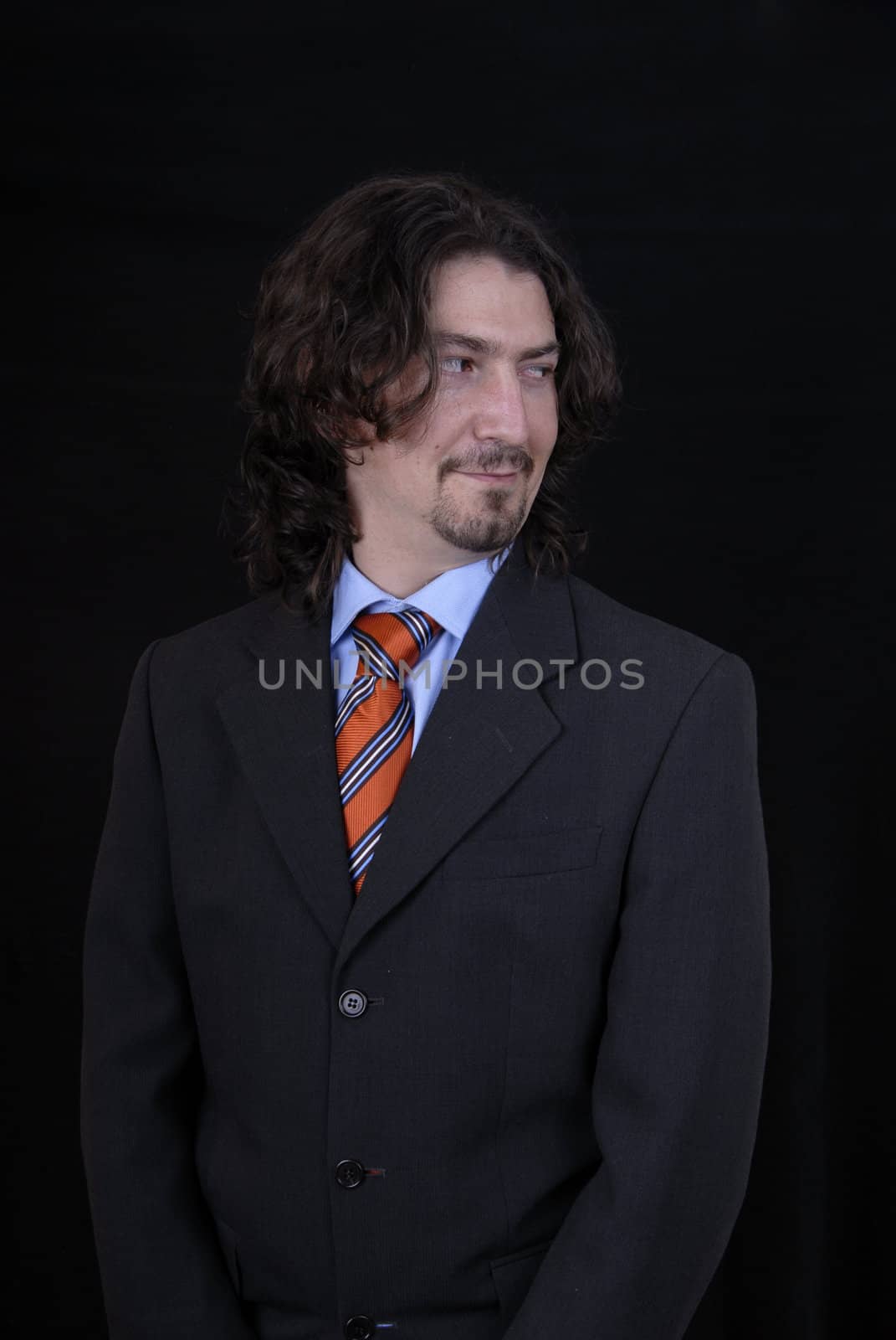 young business man portrait on black background