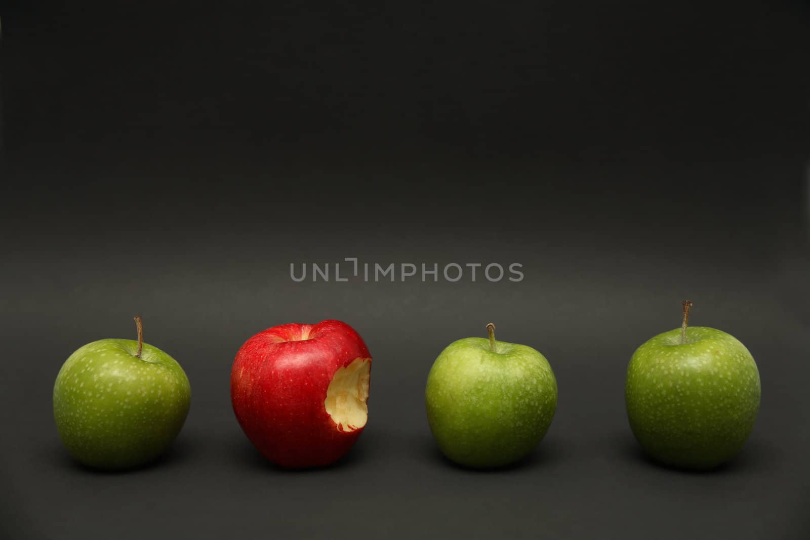 A line of apples with one exception.