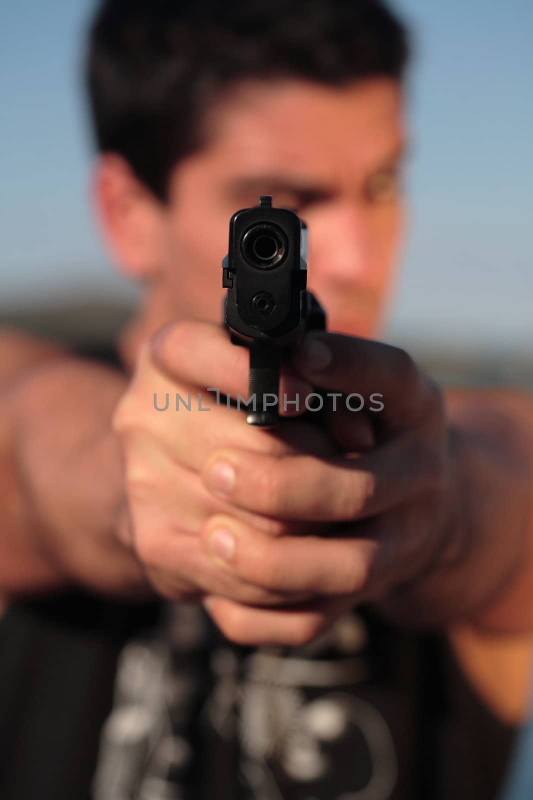 A man holding a pistol and pointing it at the camera. (This image is part of a series).

[b]PS: I'd LOVE it if you'd sitemail me to let me know how/where this image is being used! :) Cheers! ;)[/b]