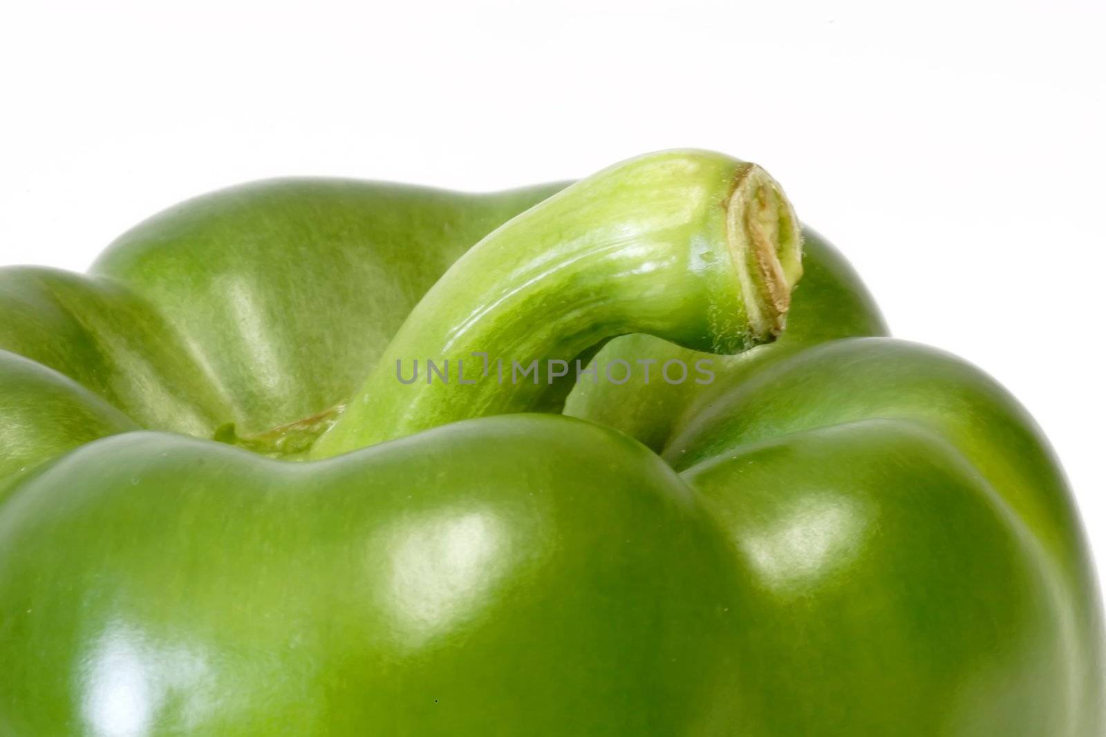 Close up of a green paprika on white background