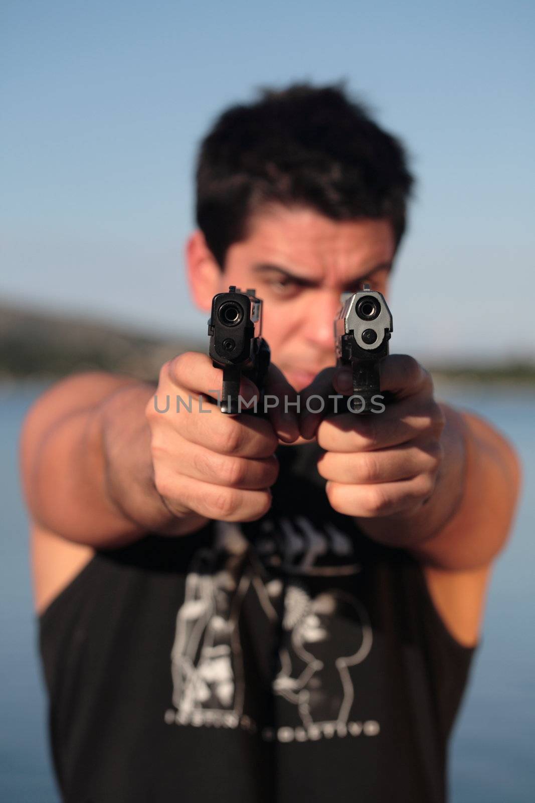 A man holding a pistol and pointing it at the camera. (This image is part of a series).

[b]PS: I'd LOVE it if you'd sitemail me to let me know how/where this image is being used! :) Cheers! ;)[/b]