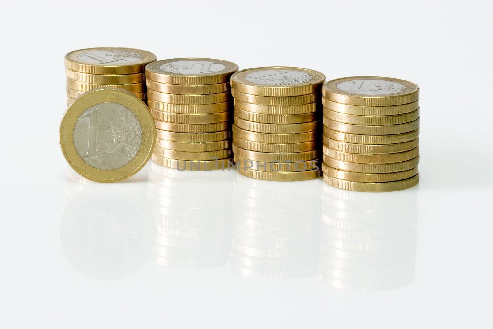 Stacks of Euro coins on light background