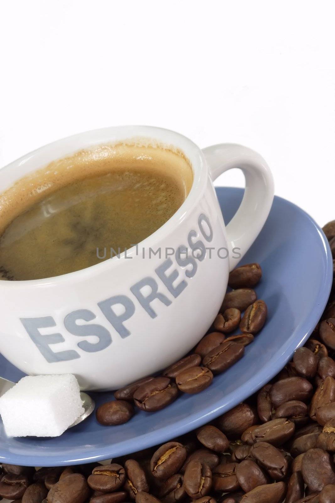 Cup of espresso with coffee beans on light background