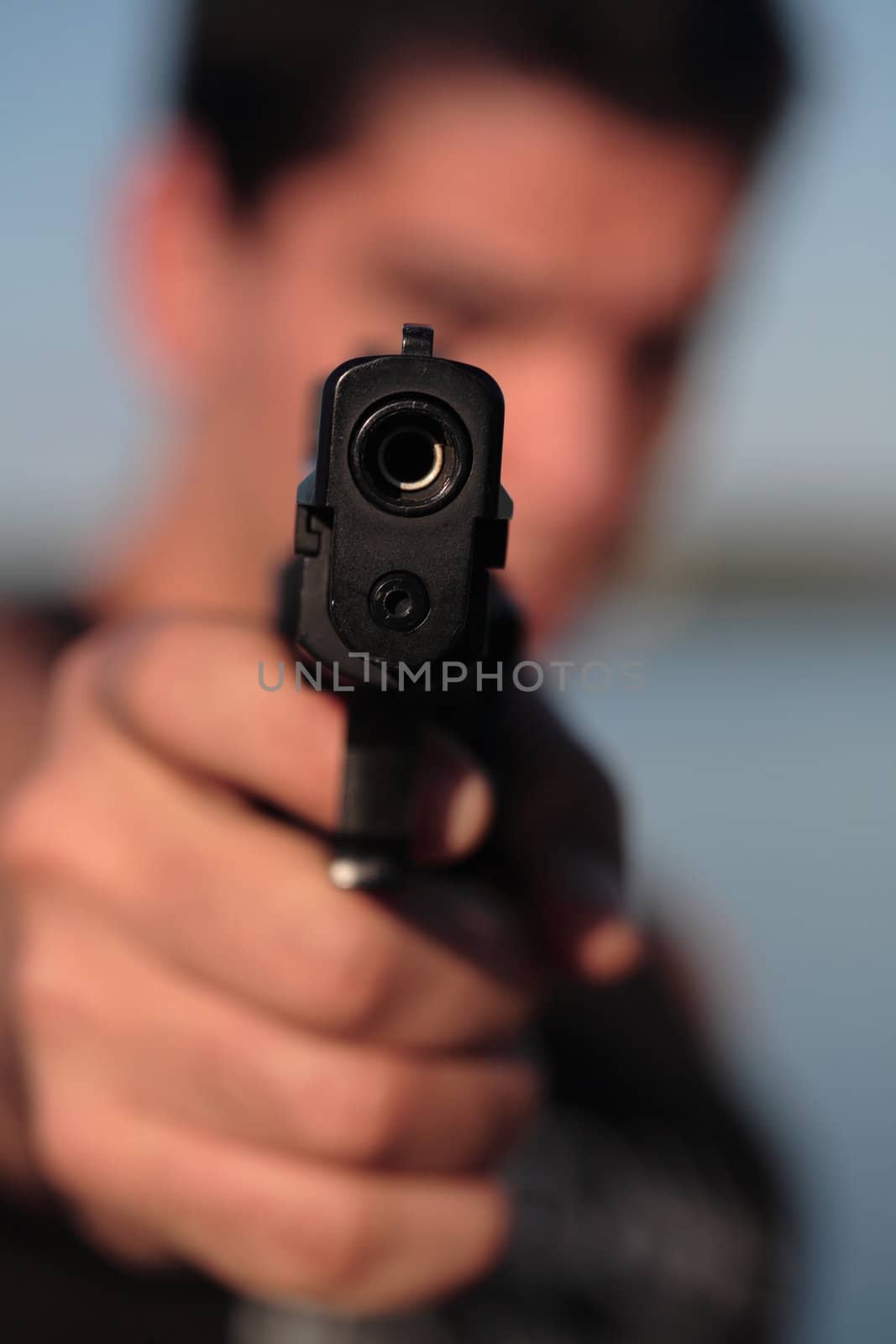 A man holding a pistol and pointing it at the camera. (This image is part of a series).

[b]PS: I'd LOVE it if you'd sitemail me to let me know how/where this image is being used! :) Cheers! ;)[/b]