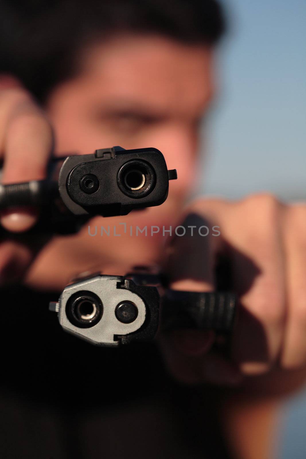 A man holding a pistol and pointing it at the camera. (This image is part of a series).

PS: I'd LOVE it if you'd sitemail me to let me know how/where this image is being used! :) Cheers! ;)