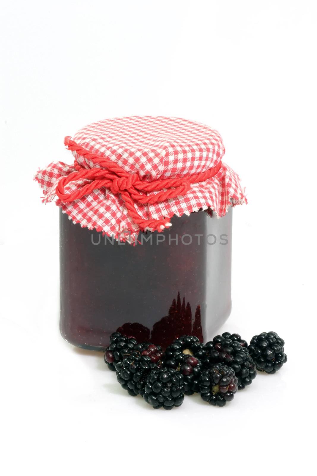 Blackberry jam in glass and nature blackberries
