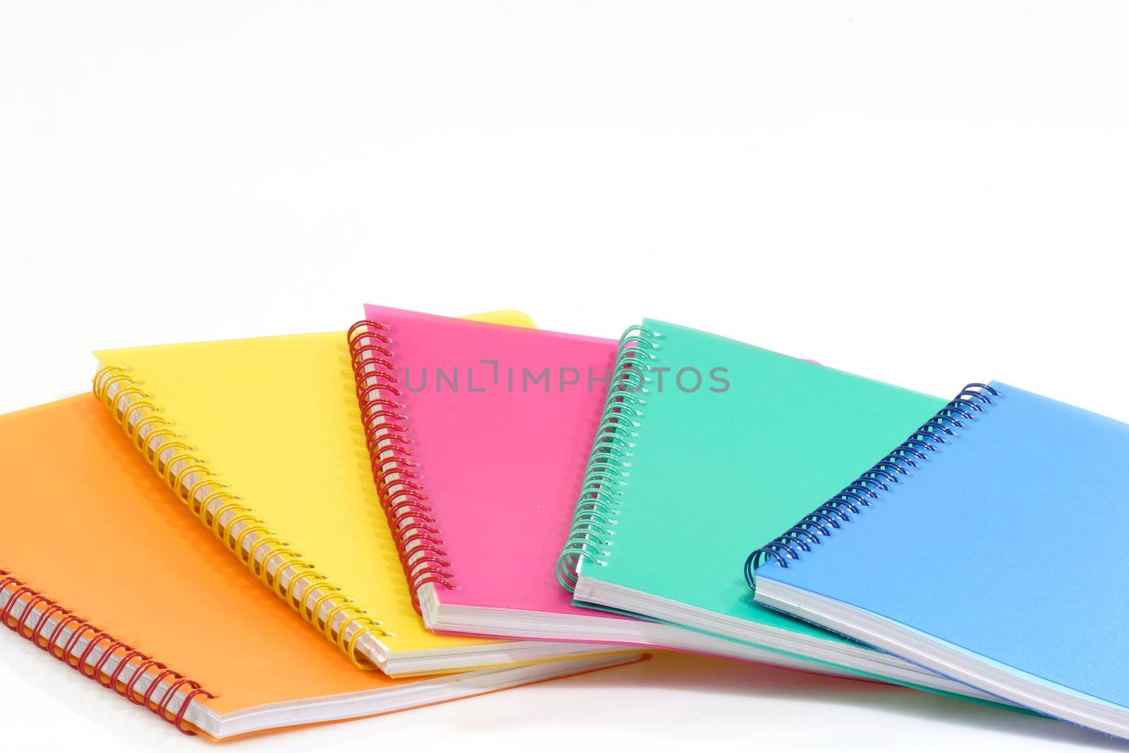Colorful ring bound books that are isolated on white Background.