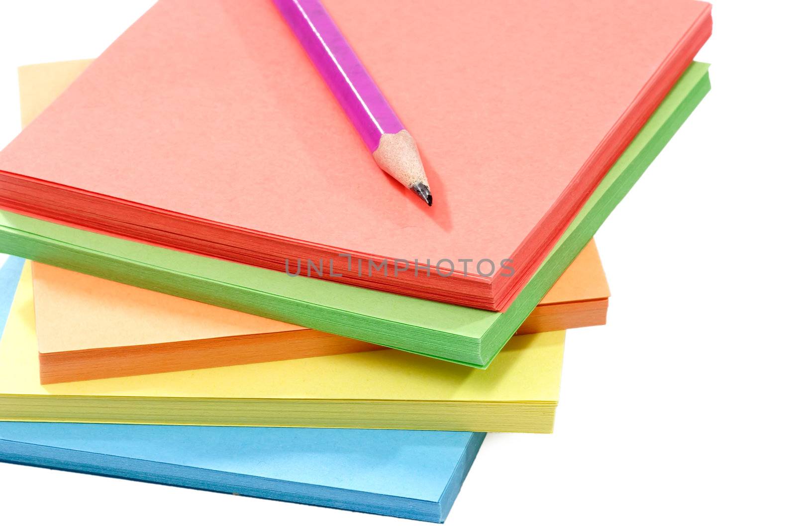 Batch of assorted color paper over white background