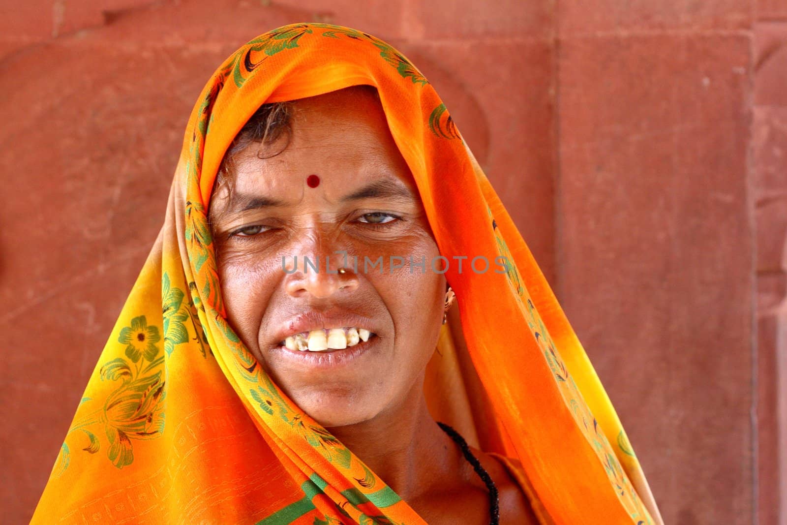 Old woman wearing a beautifully embroidered sari