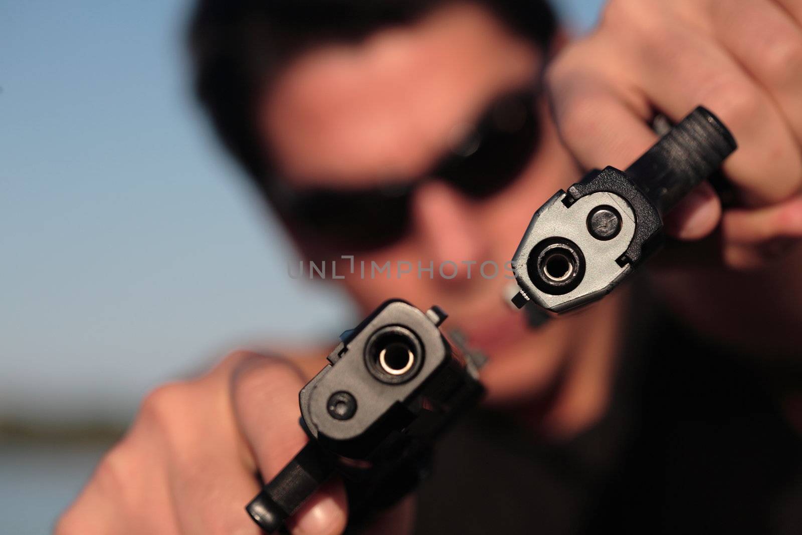 A man holding a pistol and pointing it at the camera. (This image is part of a series).

[b]PS: I'd LOVE it if you'd sitemail me to let me know how/where this image is being used! :) Cheers! ;)[/b]