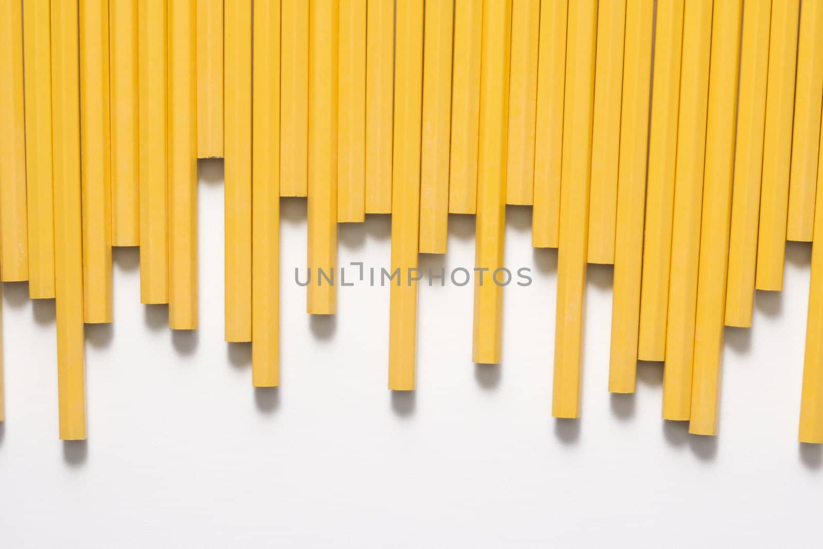 Uneven row of unsharpened pencils.