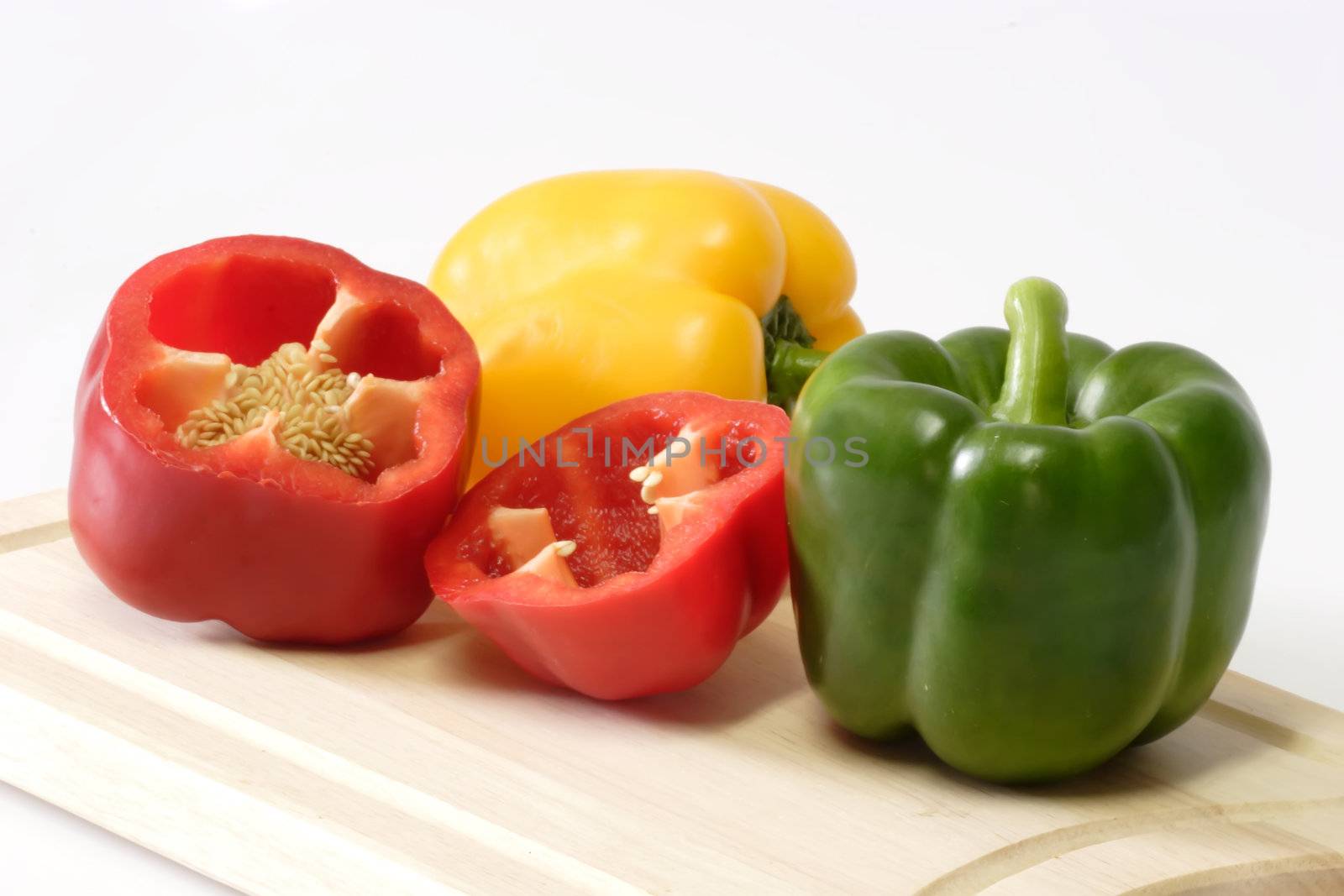 Peppers on Kitchen Board by Teamarbeit