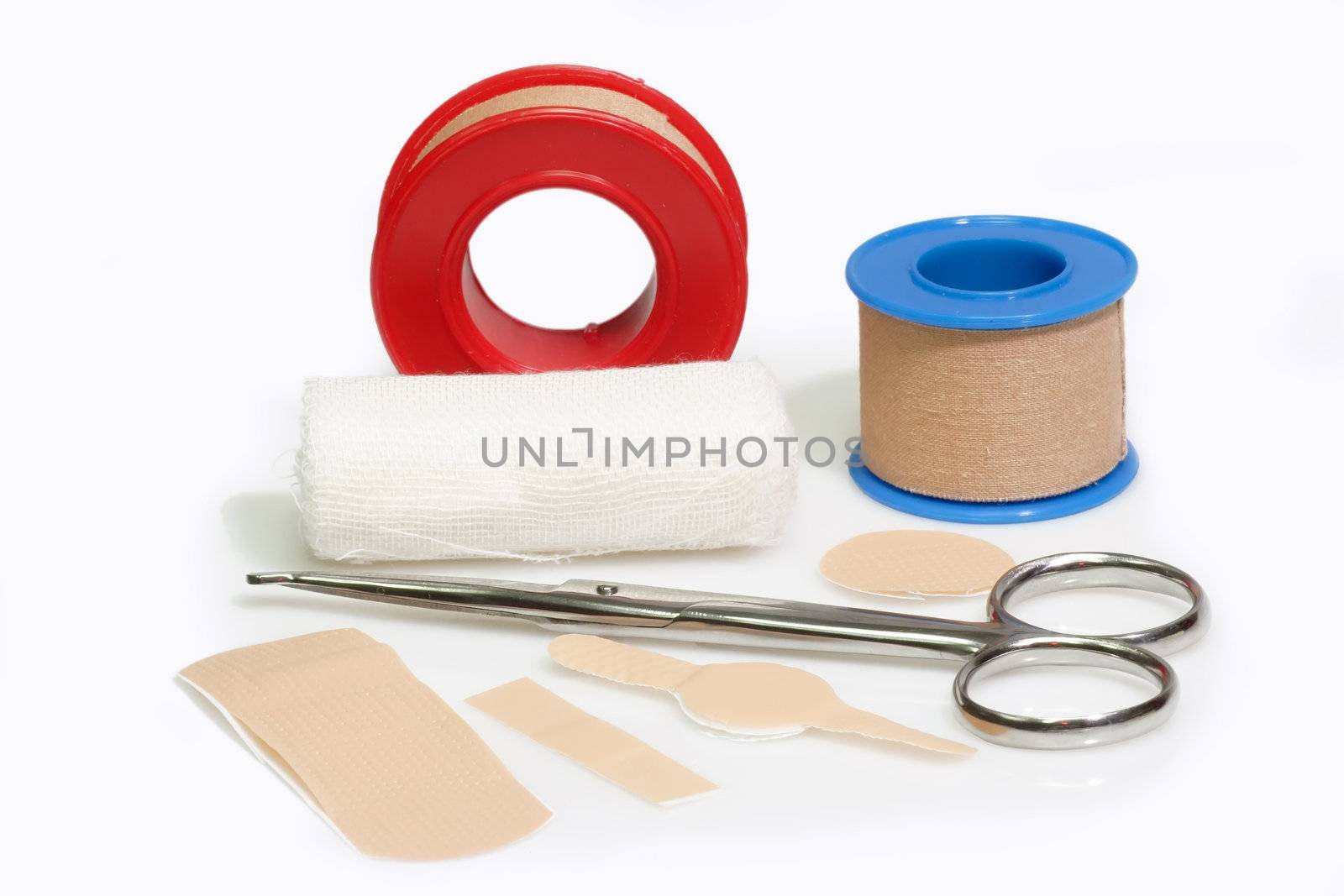First aid kit and bandageon a bright background.