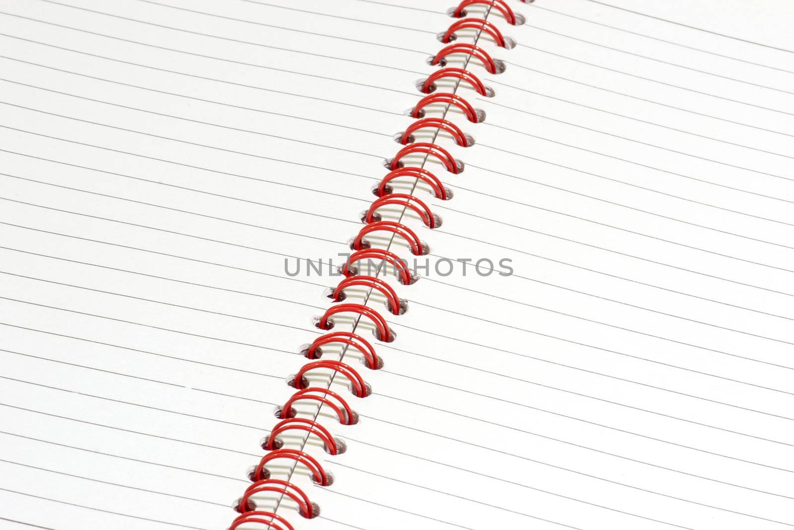 Close up of a ringbound red notepad