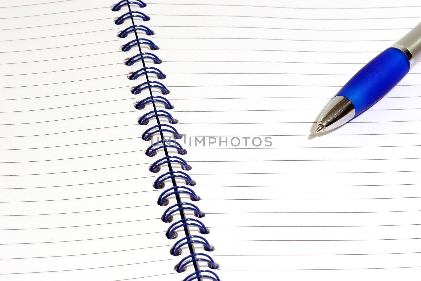 Close up of a blue notepad with ballpen