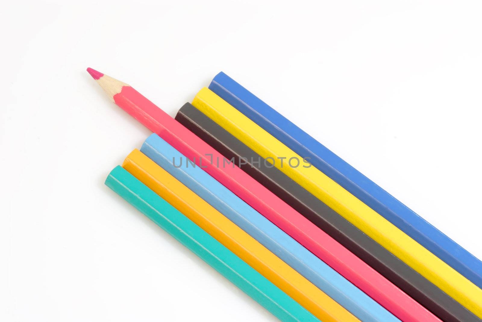 Close up of multicolored crayons on bright background