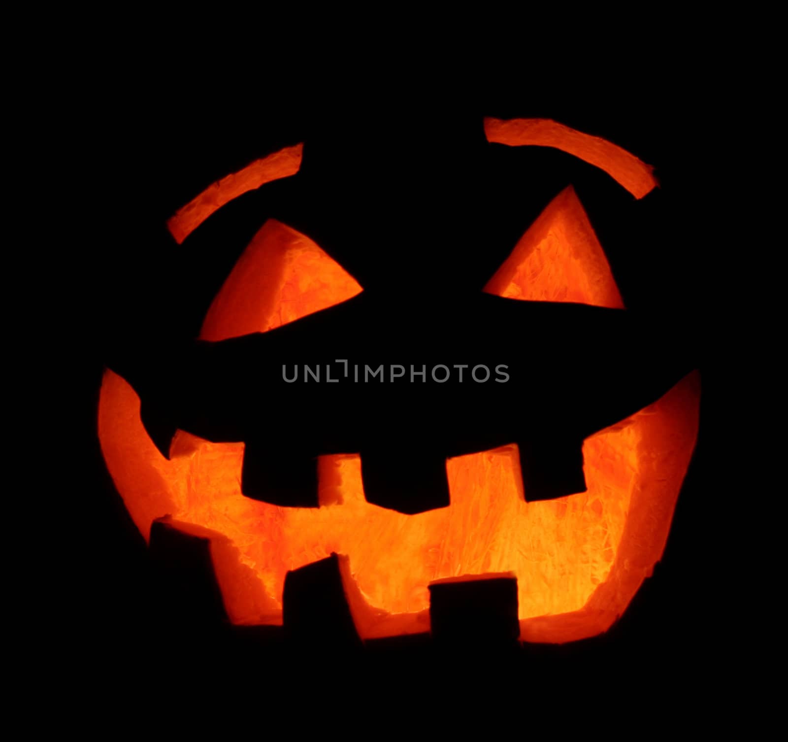 A smiling carved Halloween pumpkin face.