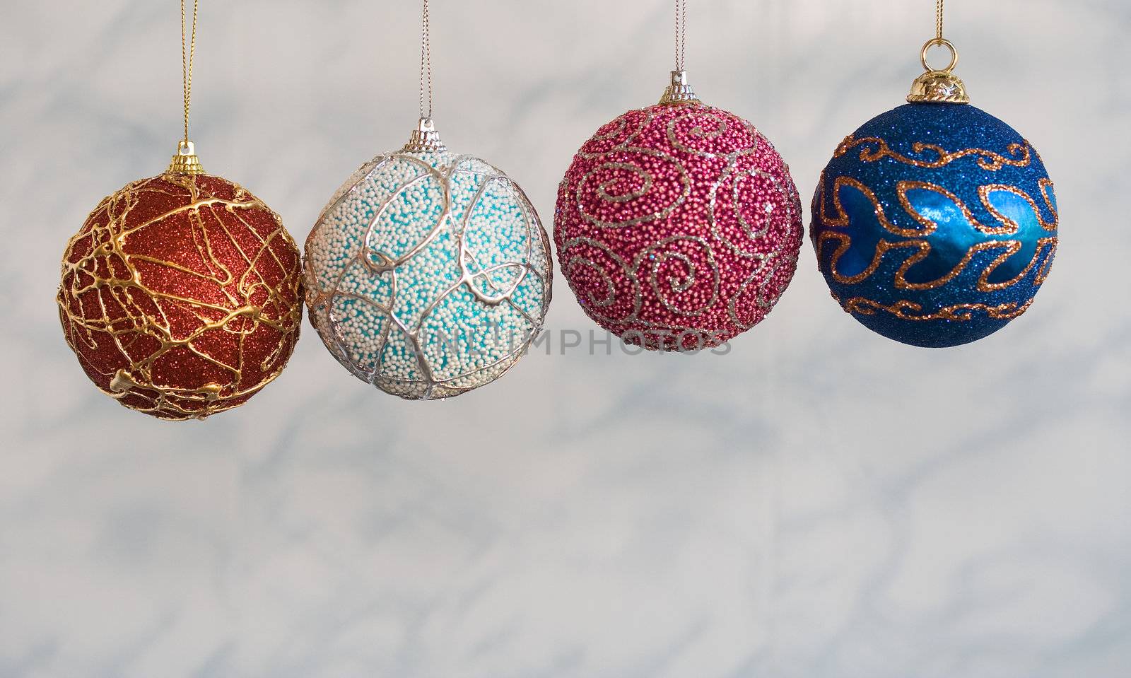 Four handicraft christmas balls of different colors