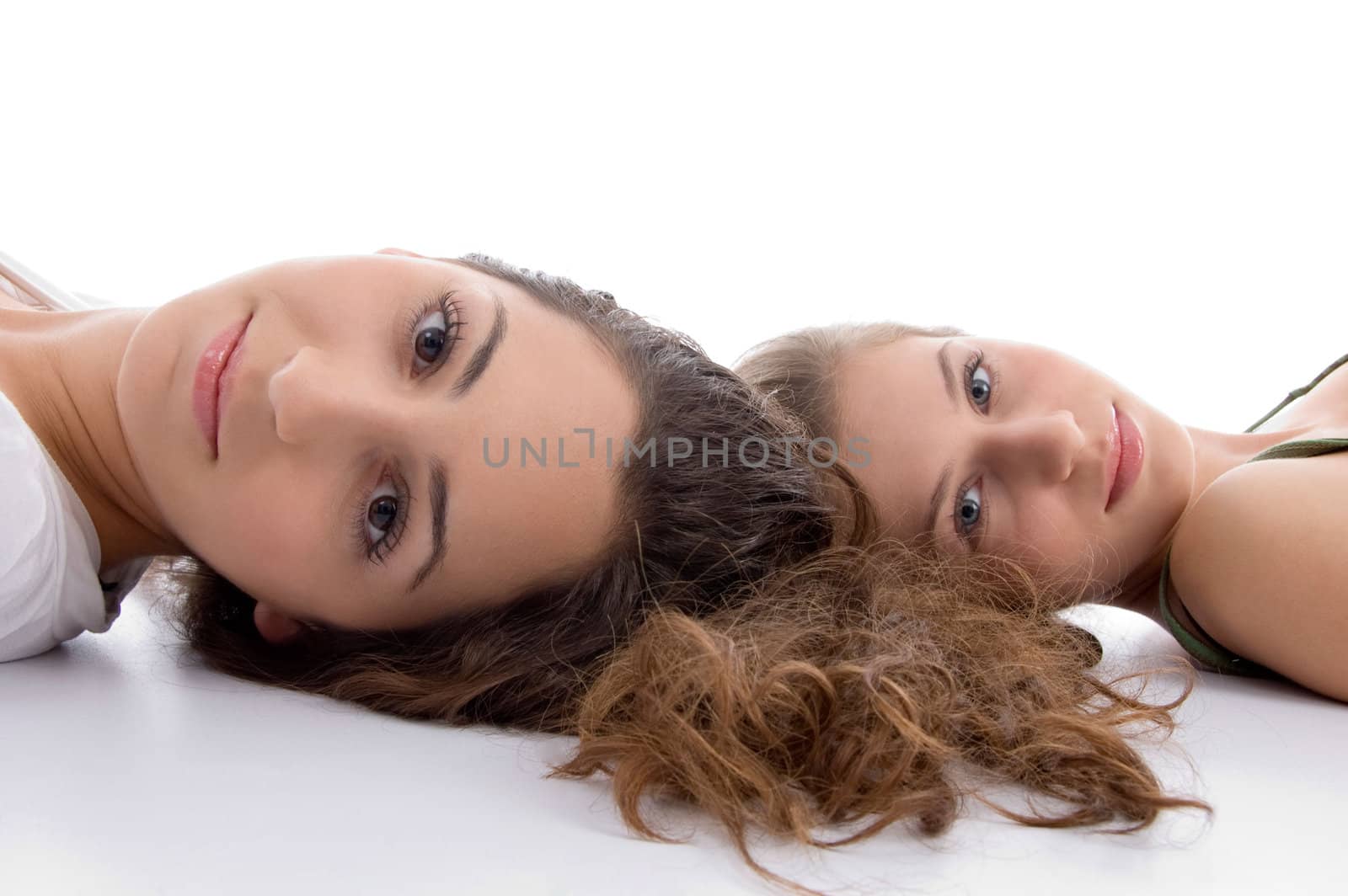 two friends lying and looking at camera isolated on white background