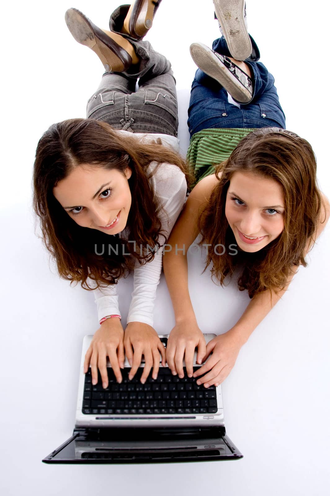 cute teenager girls busy on laptop isolated on white background
