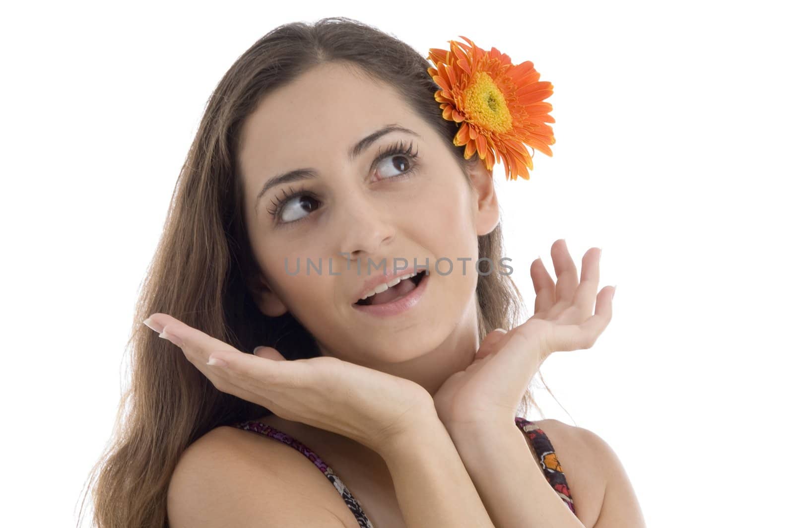 female with gerbera in hair giving surprising expression on an isolated white background