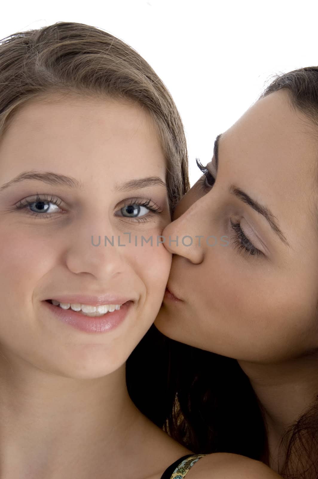 female kissing her friend on an isolated white background