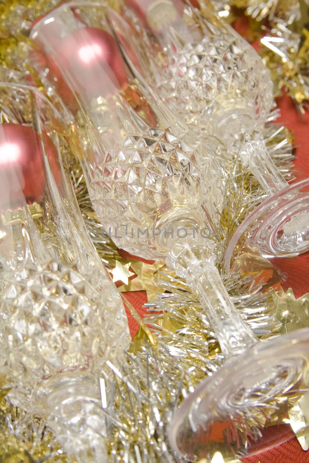 Three glasses with Christmas decoration on red background.