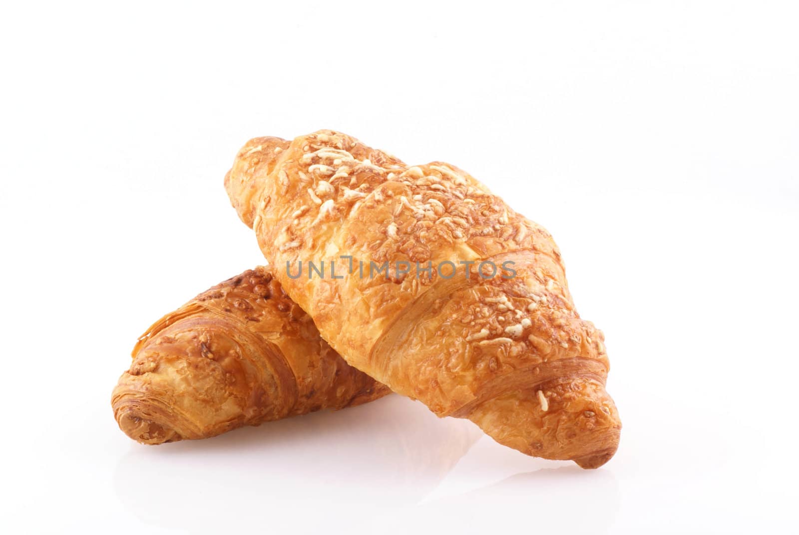 Two delicious french croissants isolated on white.
