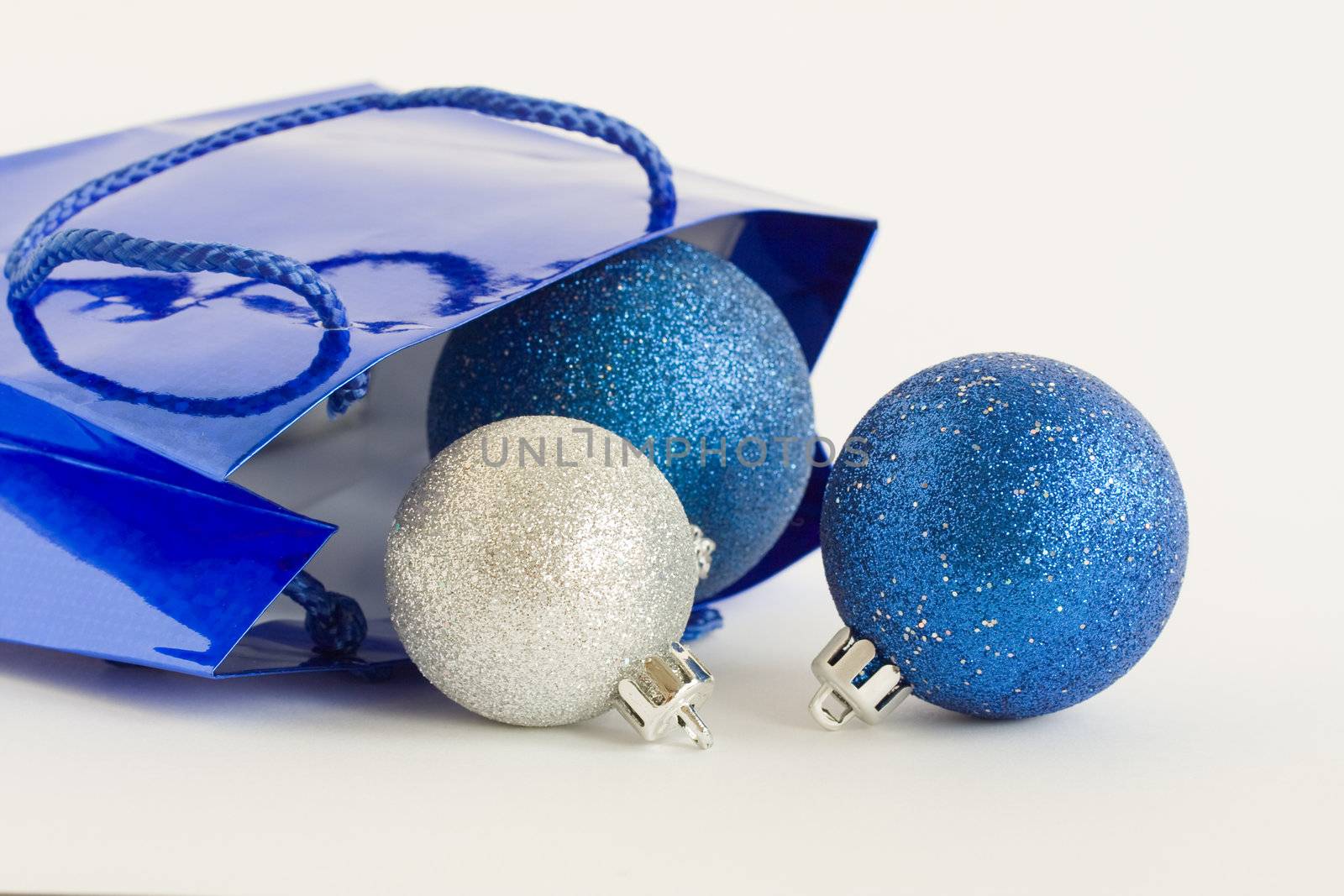 Blue bag and Christmas balls o white background