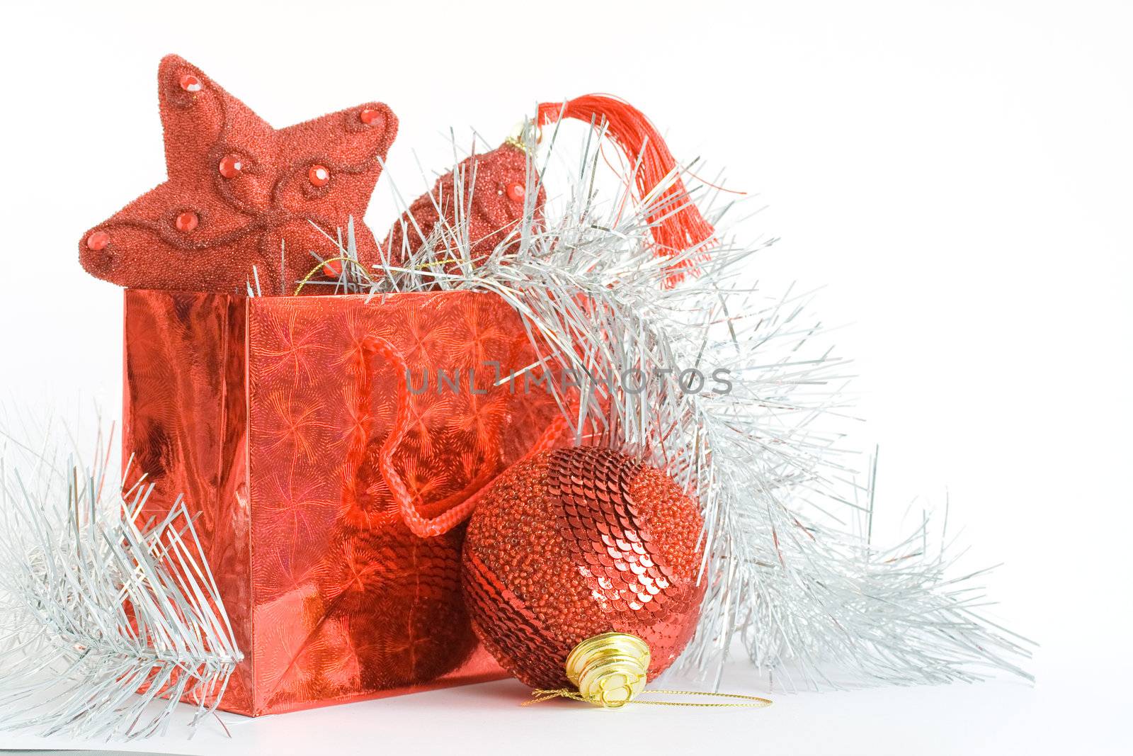 Red bag with christmas toys on white background by serpl