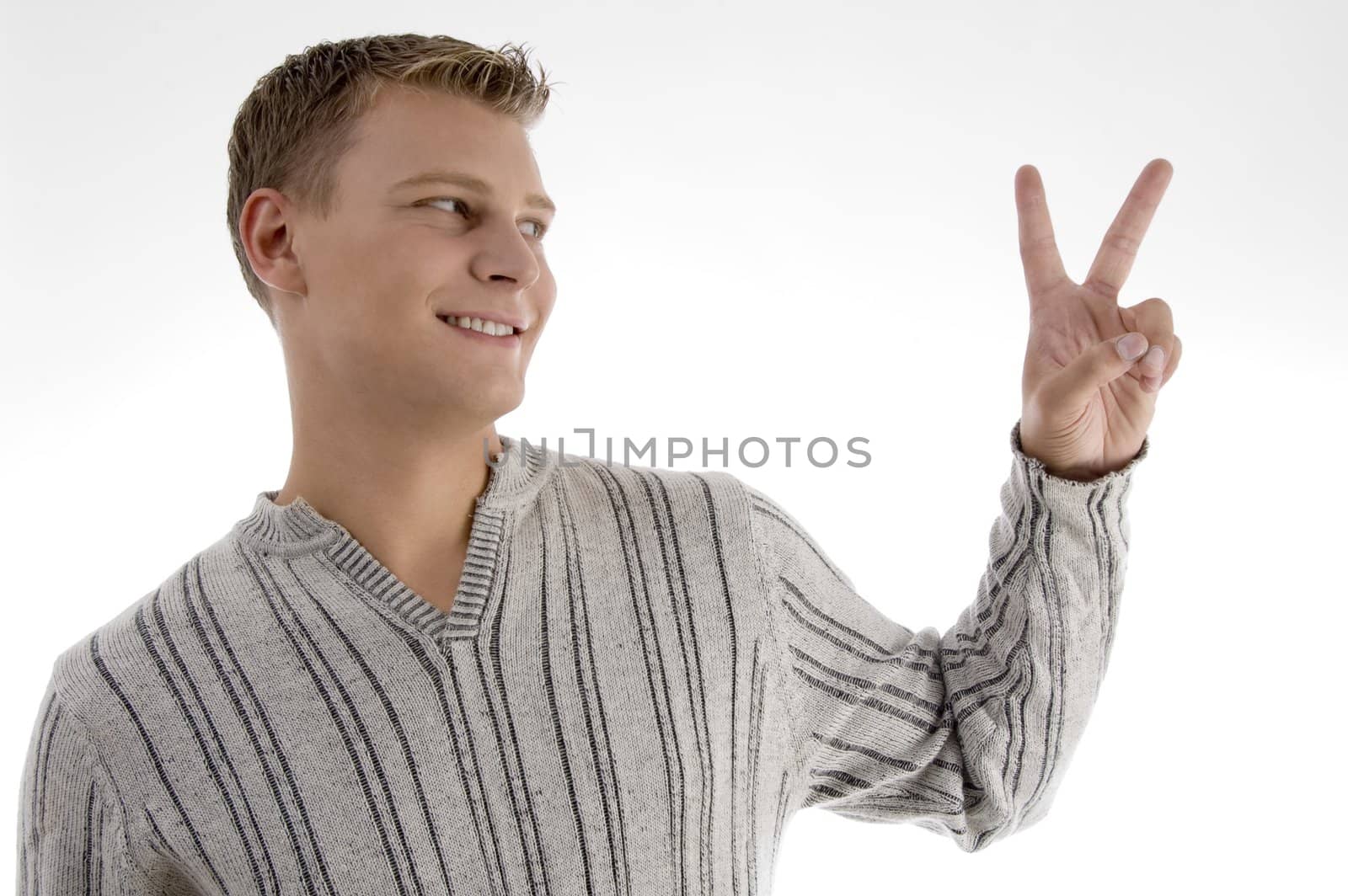 successful young man showing peace sign against white background