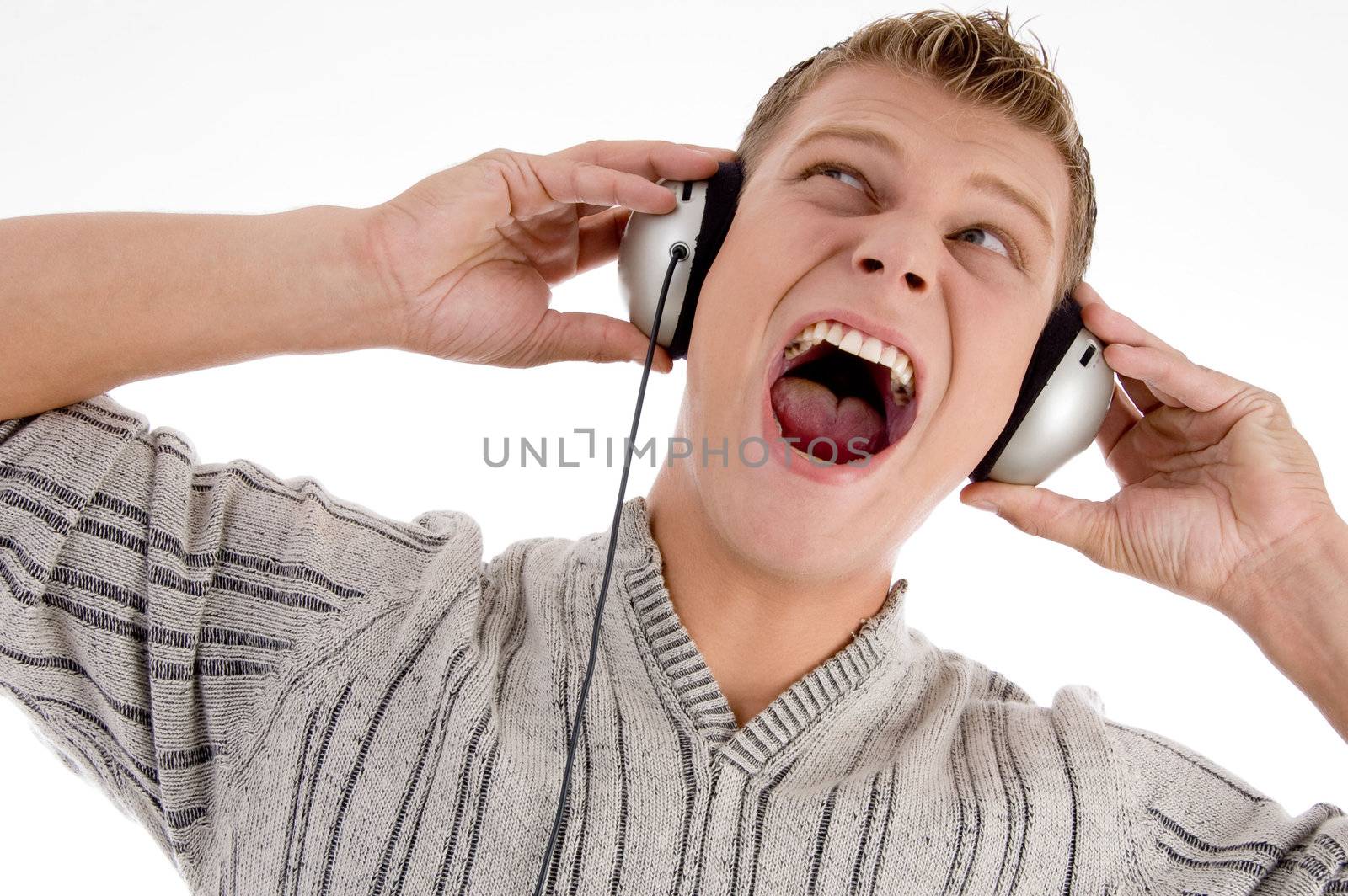 shouting man with headphone looking upward by imagerymajestic